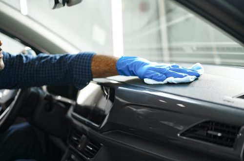 A man cleaning car interior, car detailing in Carwash service