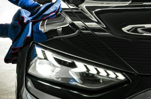 Car Wash and Detailing Worker Cleaning a Car with Soft Cloth